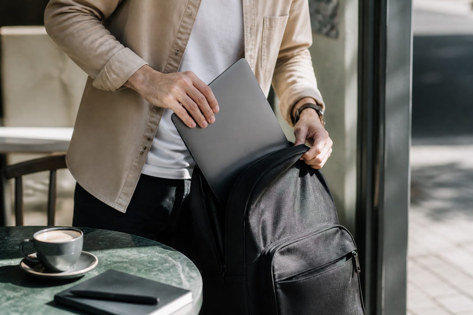 Thin laptop being placed into a backpack