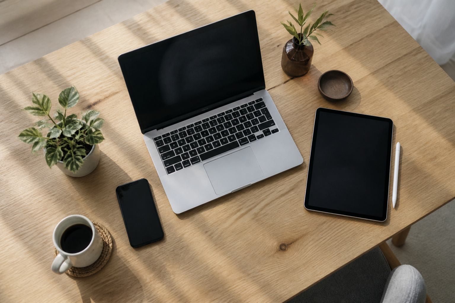 Laptop, phone and tablet arranged on a table