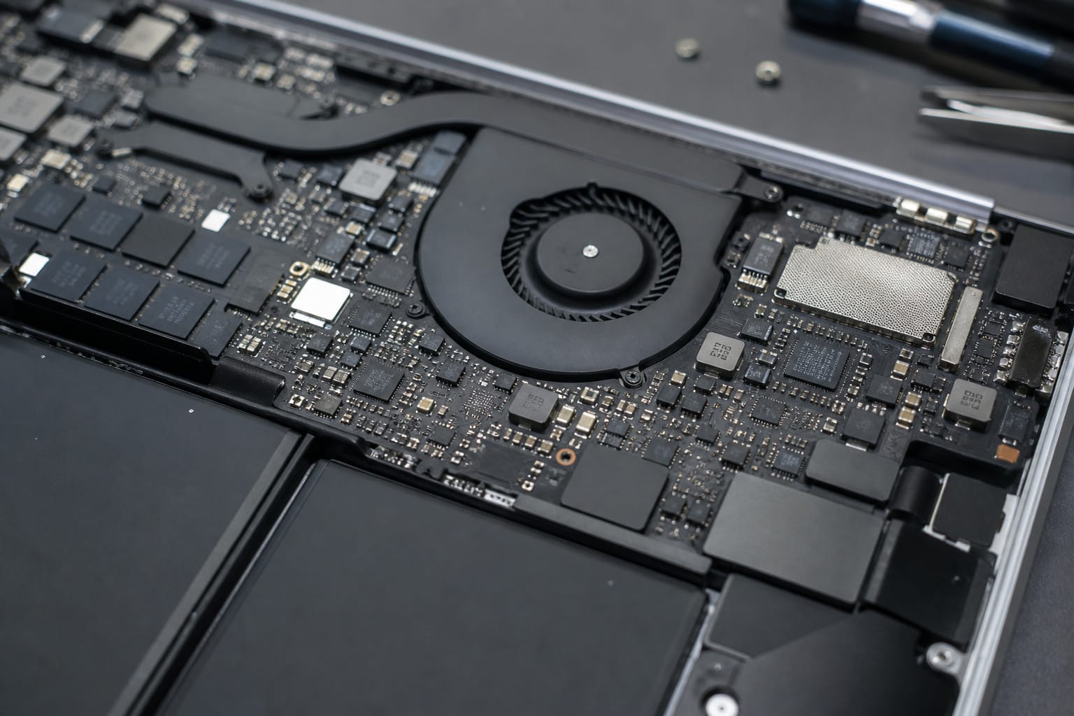 Opened thin laptop showing soldered components