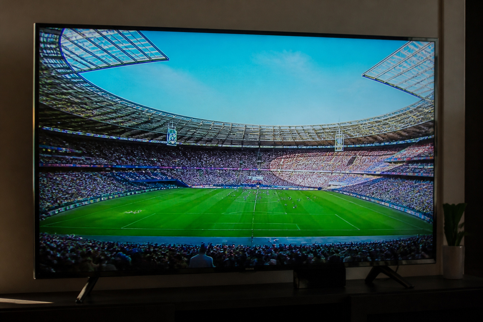 TV showing a live sports broadcast in a bright stadium