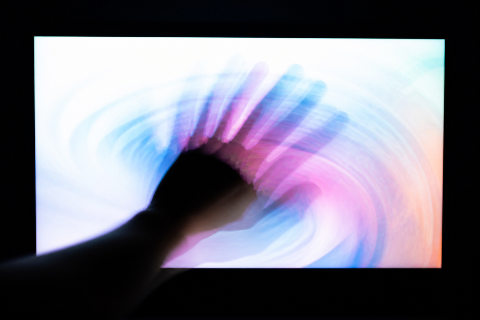 Motion trails in front of a bright screen