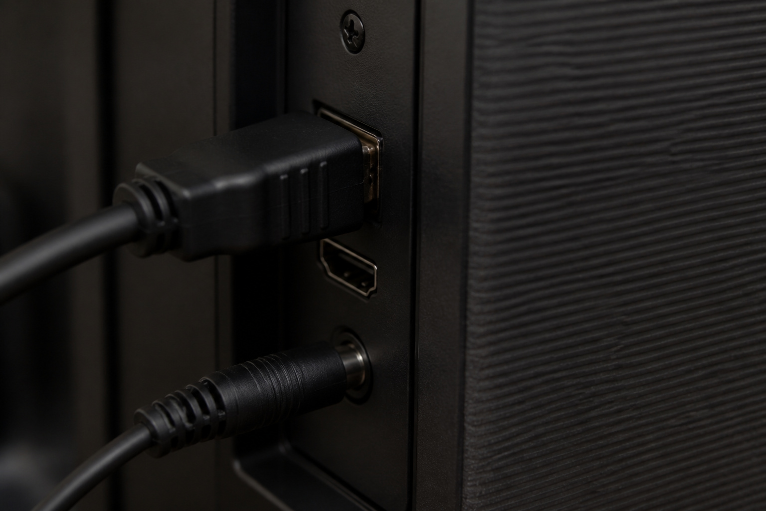 HDMI cable plugged into the back of a TV and soundbar