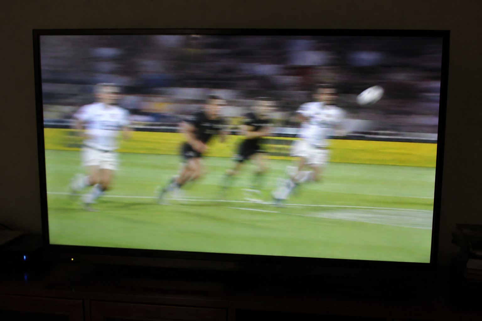 TV showing a fast sports play with a smeared ball