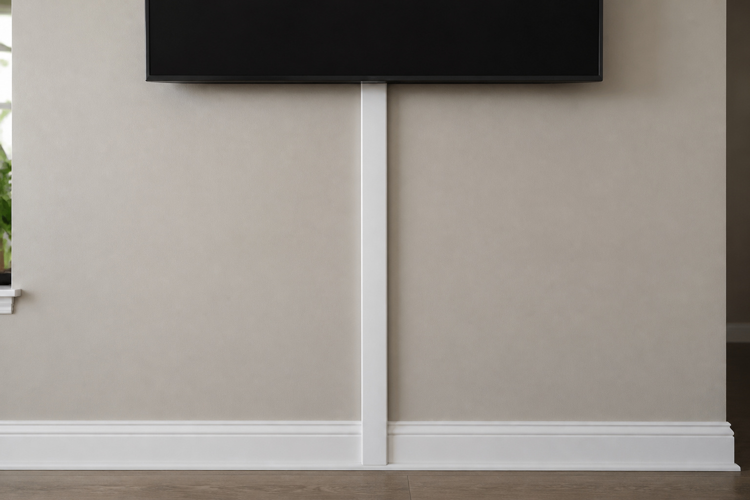 Paintable cord cover running down a wall from a TV