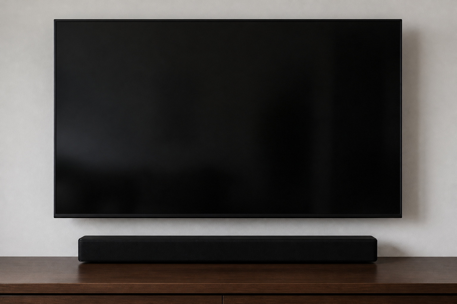 Soundbar on a shelf directly below a wall-mounted TV