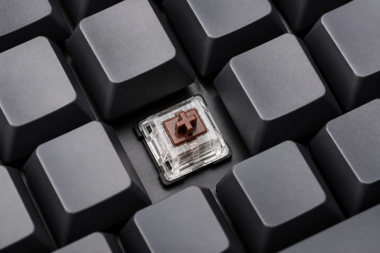 Mechanical keyboard with a keycap removed showing the switch
