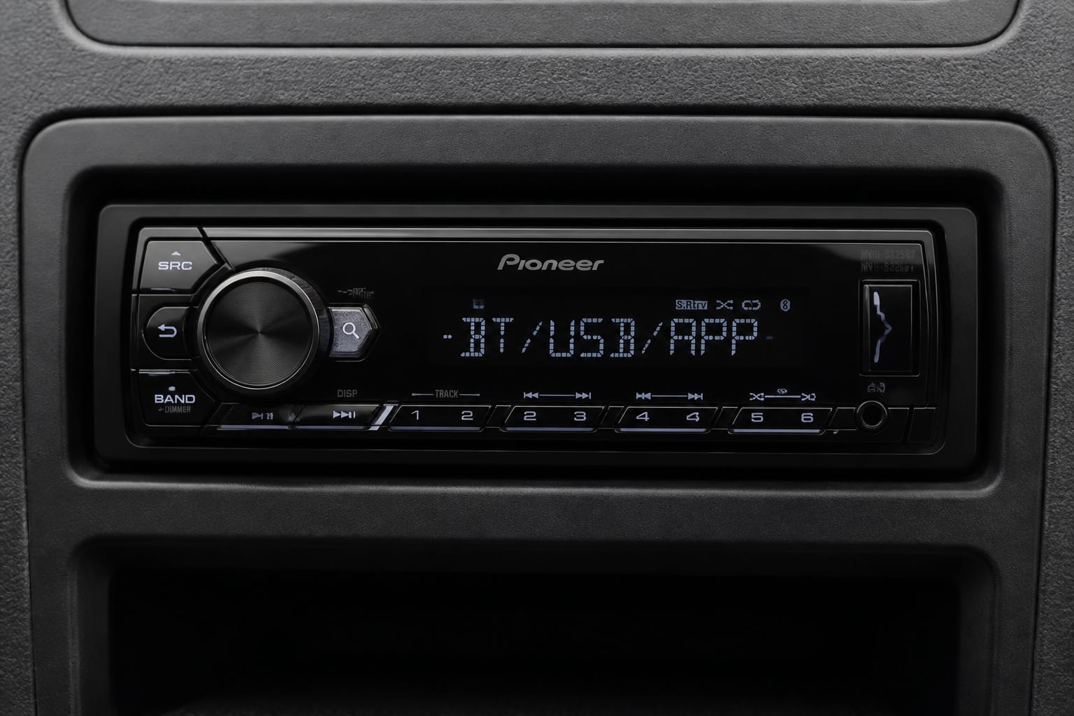 Compact single-DIN car stereo with small display installed in a dashboard