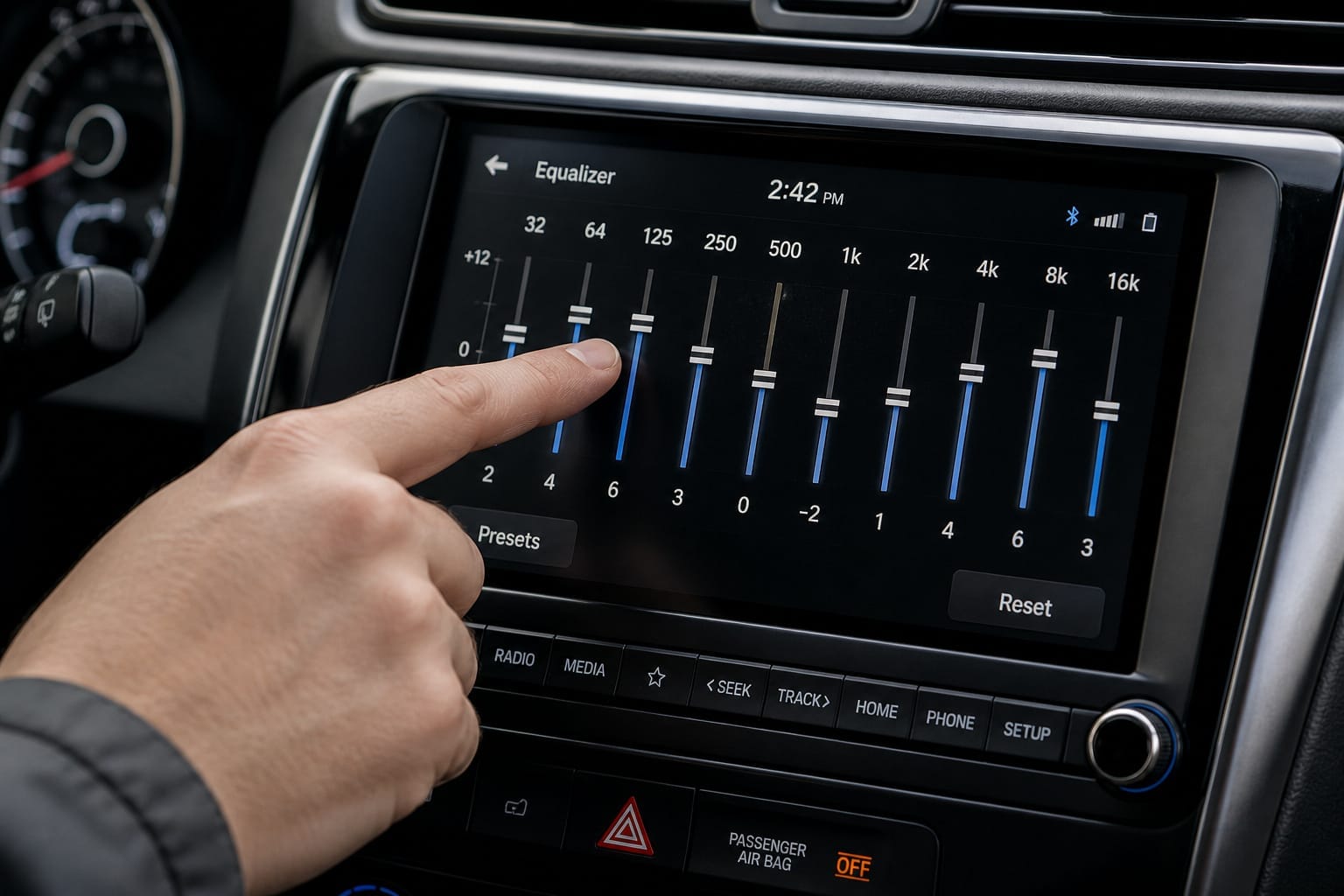 Driver adjusting car stereo equalizer settings on a touchscreen display