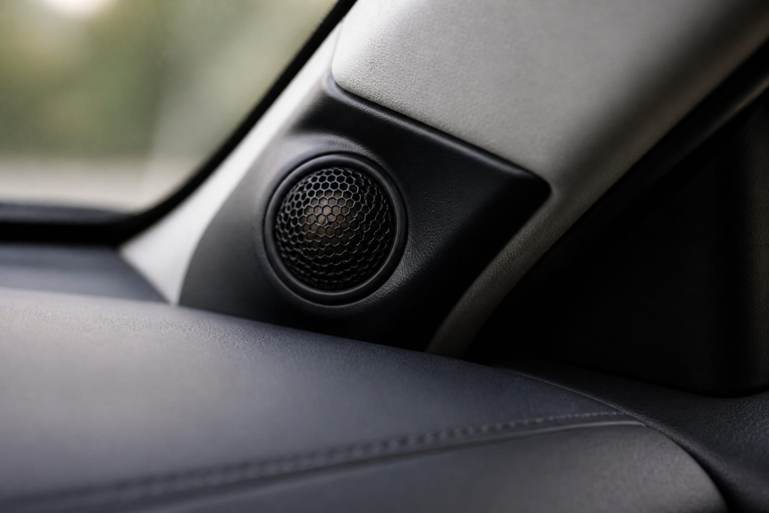 Small dome tweeter mounted in a car's A-pillar for component speakers