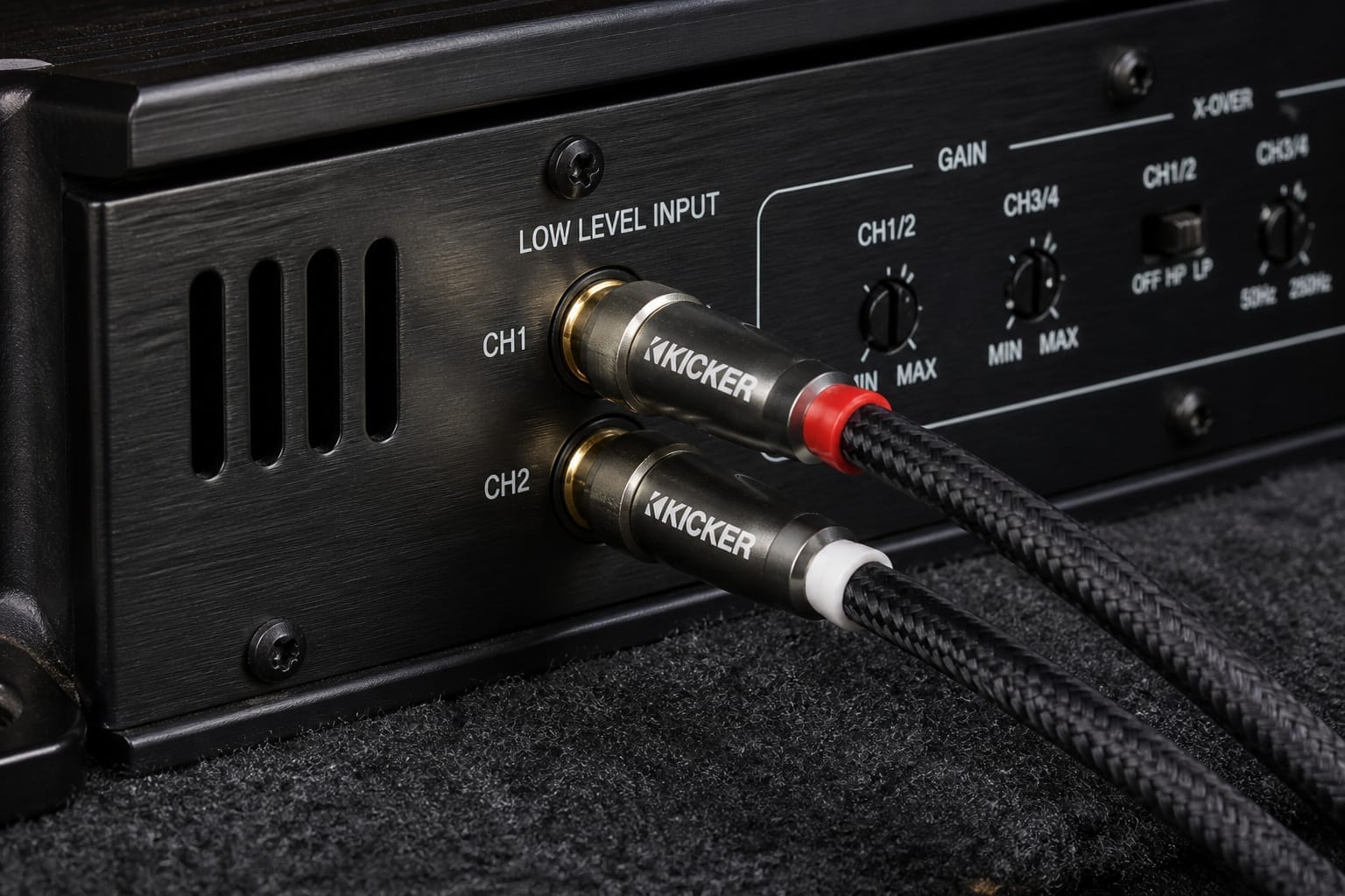 RCA cables connected to a car amplifier's low-level inputs