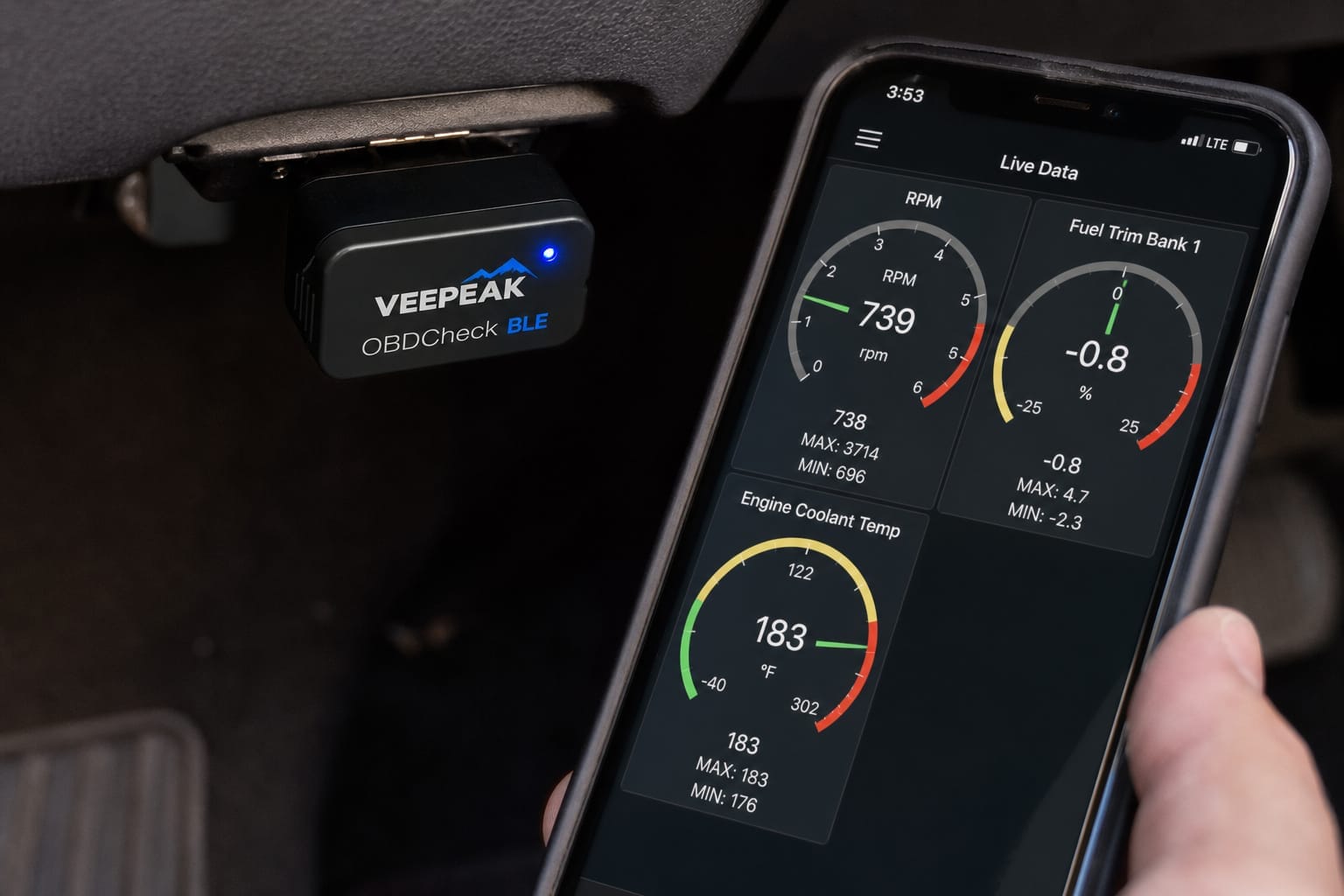 Bluetooth OBD2 dongle plugged into a car's diagnostic port with a phone app showing live data