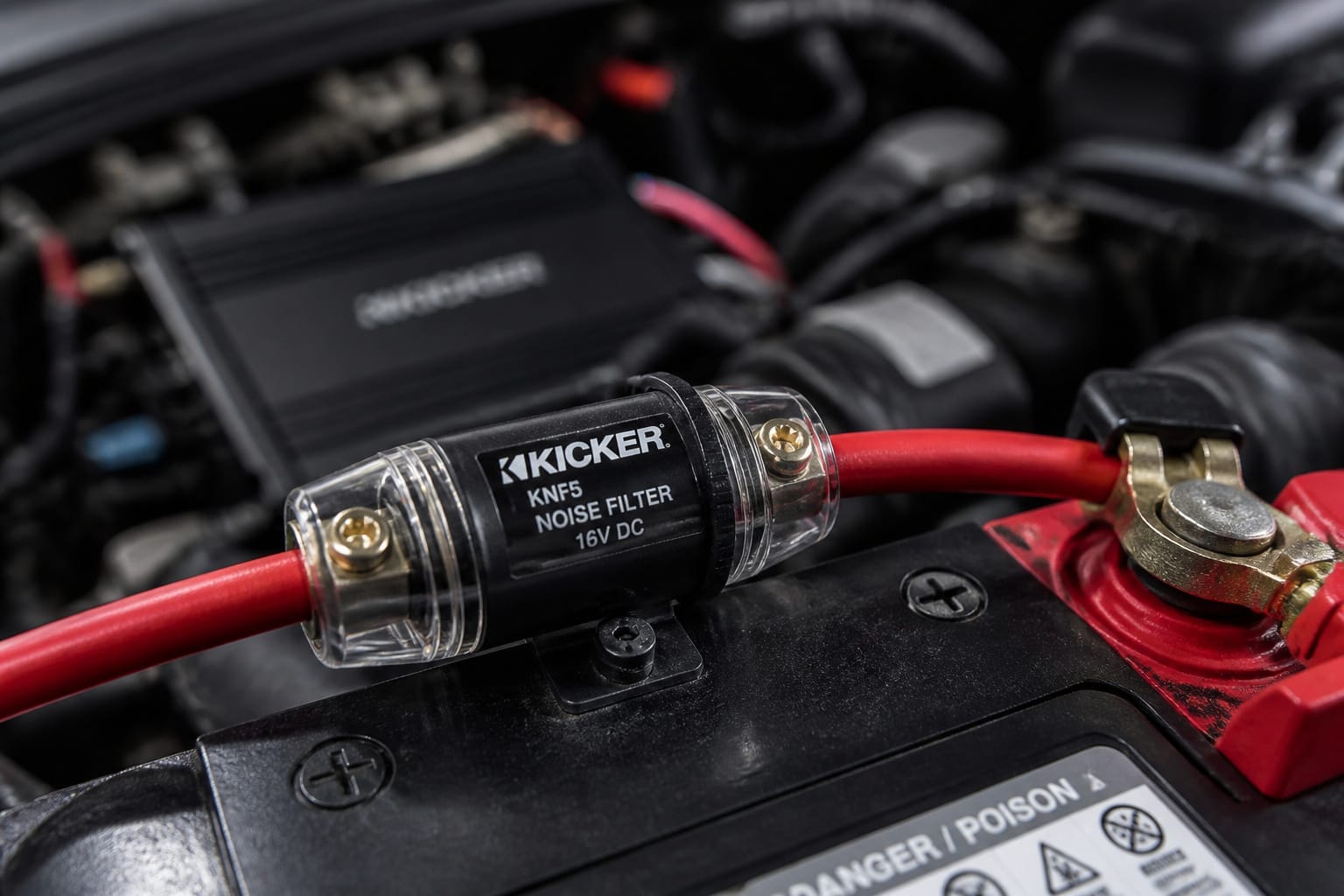 Inline noise filter installed on an amplifier's power wire near the car battery