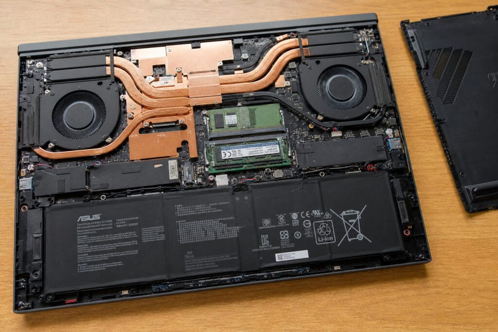 Interior of the ASUS ROG Strix SCAR 18 showing its tool-free bottom panel, cooling fans, and vapor chamber