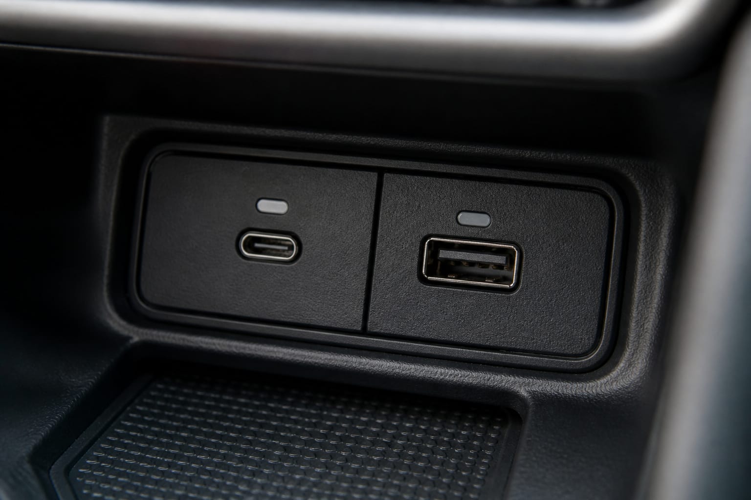 Two different USB ports in a car's center console