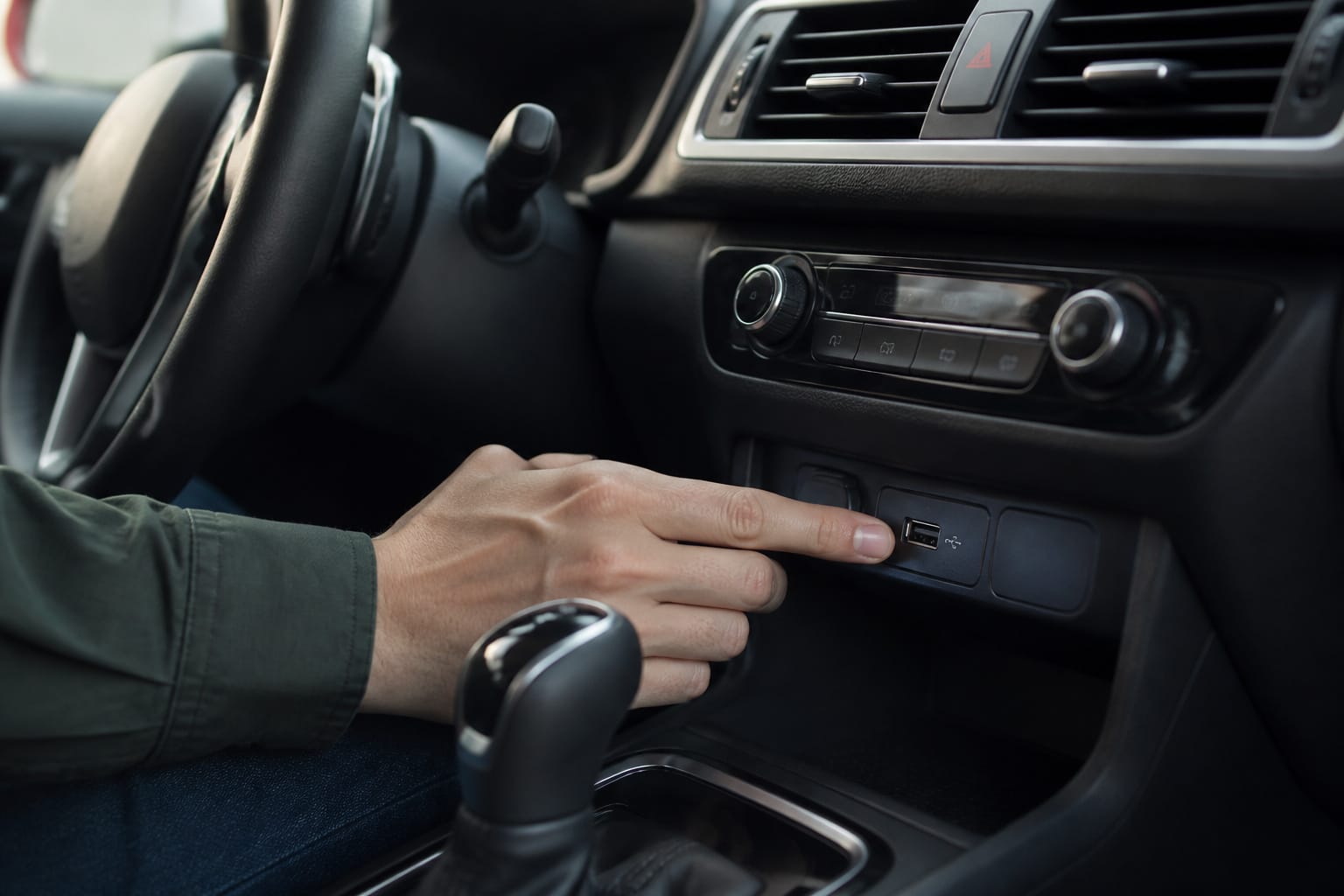 Car dashboard with a front USB port within easy reach of the driver