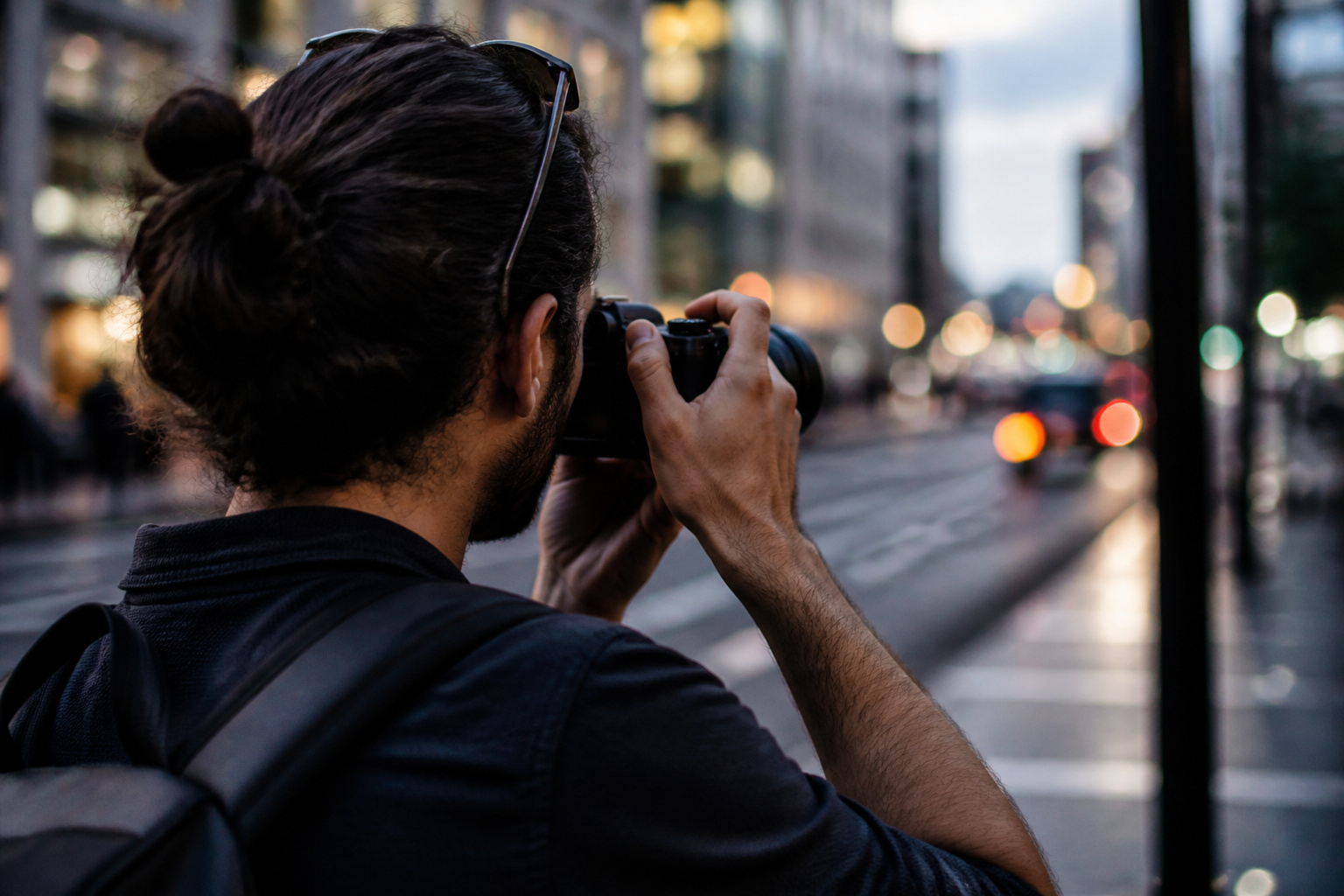Photographer holding a camera steadily on a city street