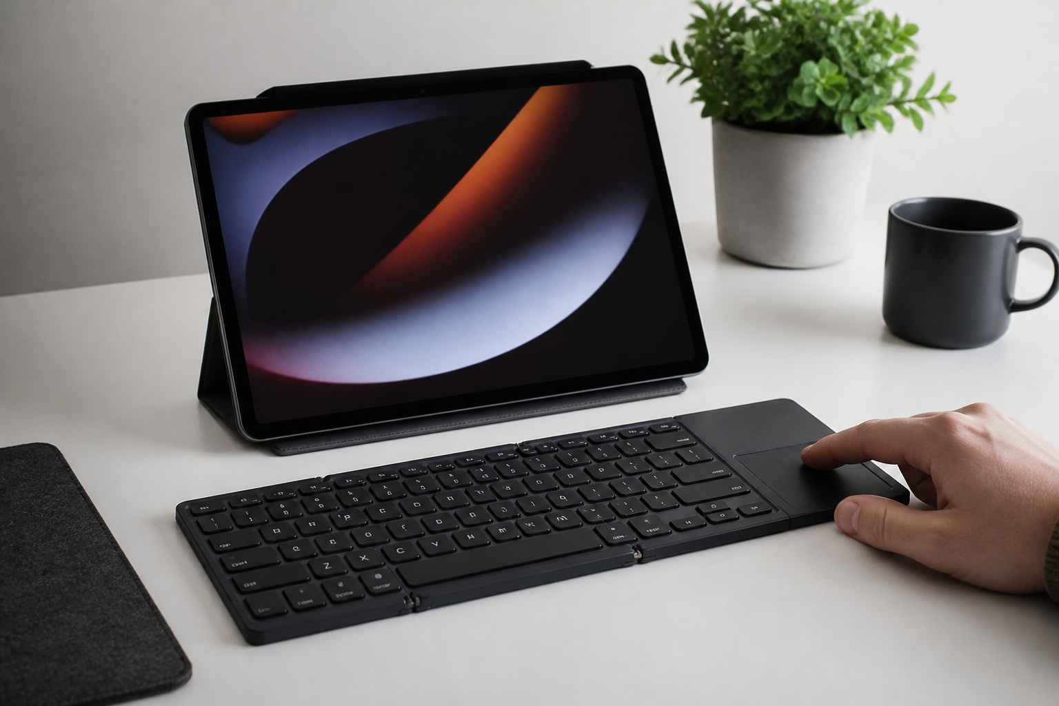 Foldable keyboard with touchpad paired with a tablet on a stand