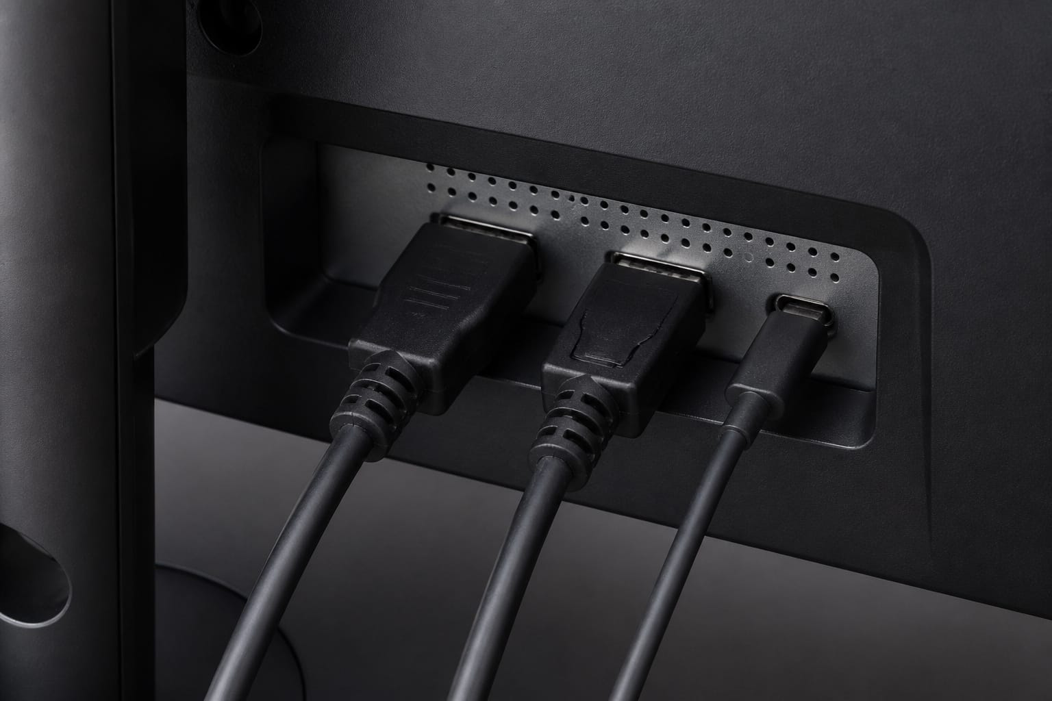 Back of a monitor with several cables plugged in