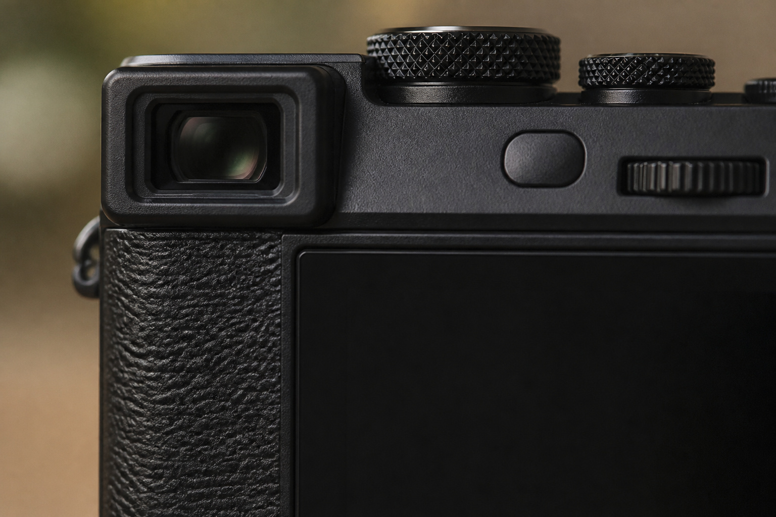 Back of a compact camera with viewfinder and dials